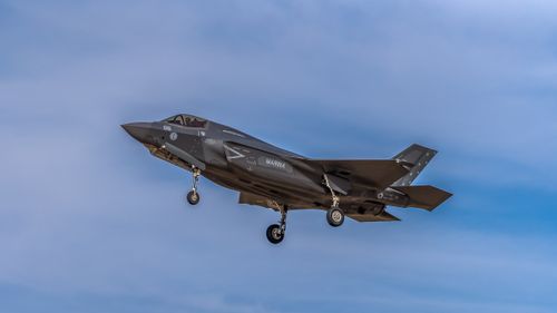 Free A Lockheed Martin F-35 fighter jet flying over Castilla-La Mancha, Spain, against a clear blue sky. Stock Photo