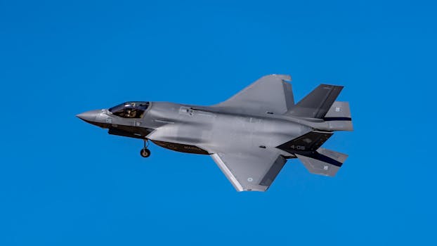 F-35 fighter jet soaring against a clear blue sky in Los Llanos, Spain.