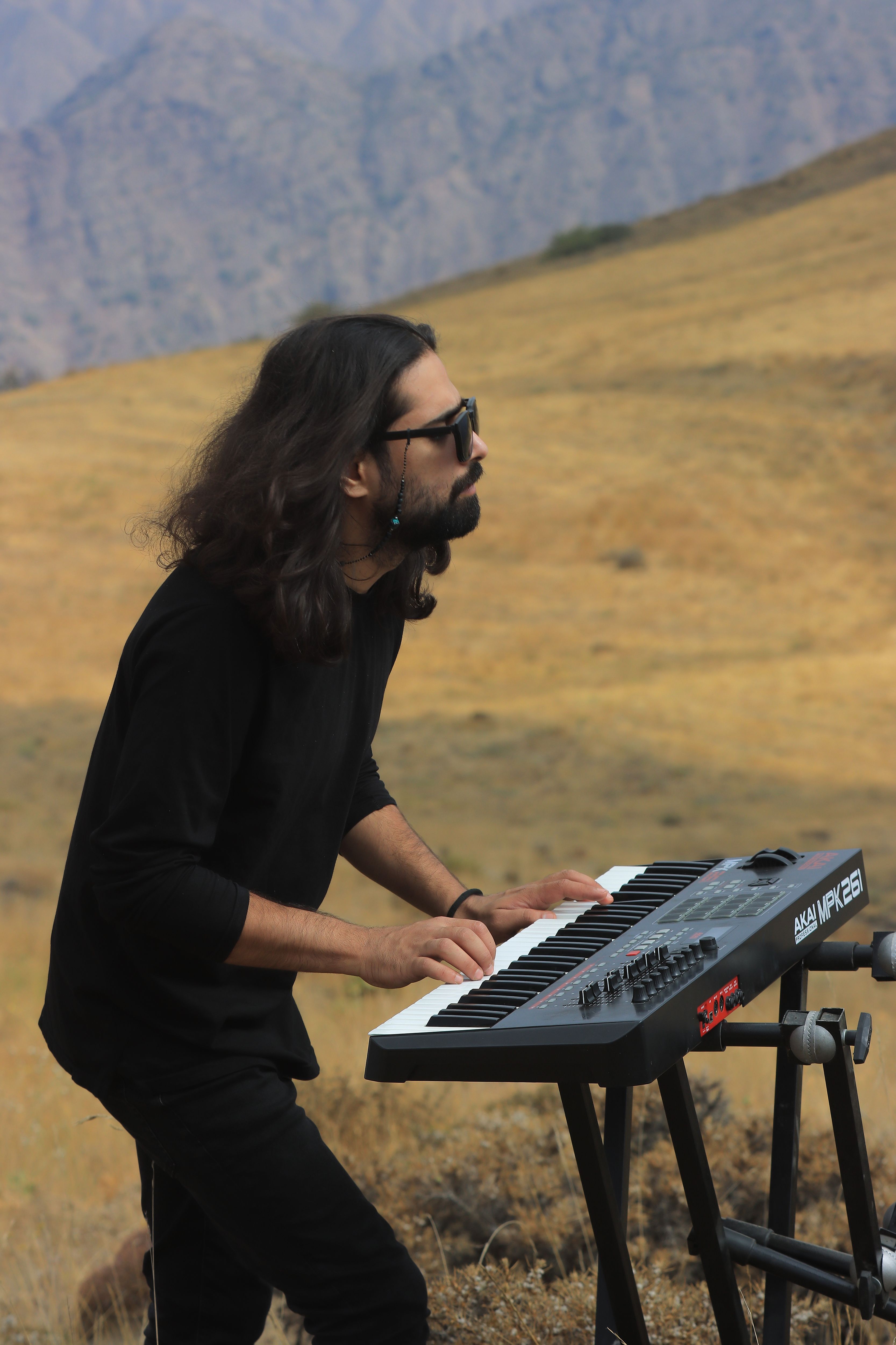 A musician performs on a keyboard in the scenic hills of Qazvin Province, Iran.