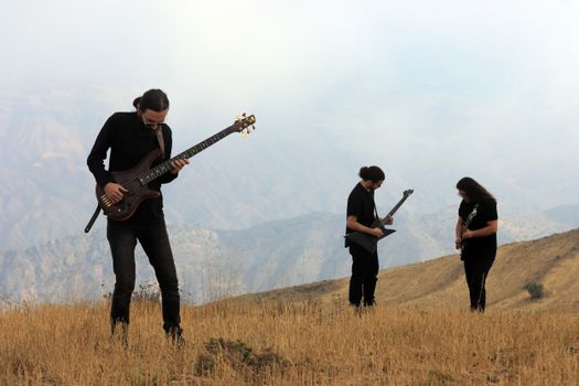 Band performing with guitars in the scenic mountains of Qazvin, Iran.