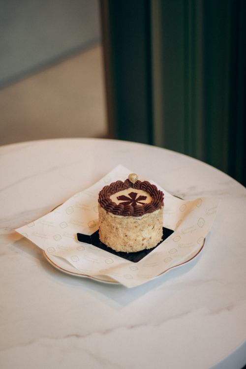 Free A close-up of a delicious pastry with chocolate decoration on a white plate, perfect for dessert. Stock Photo