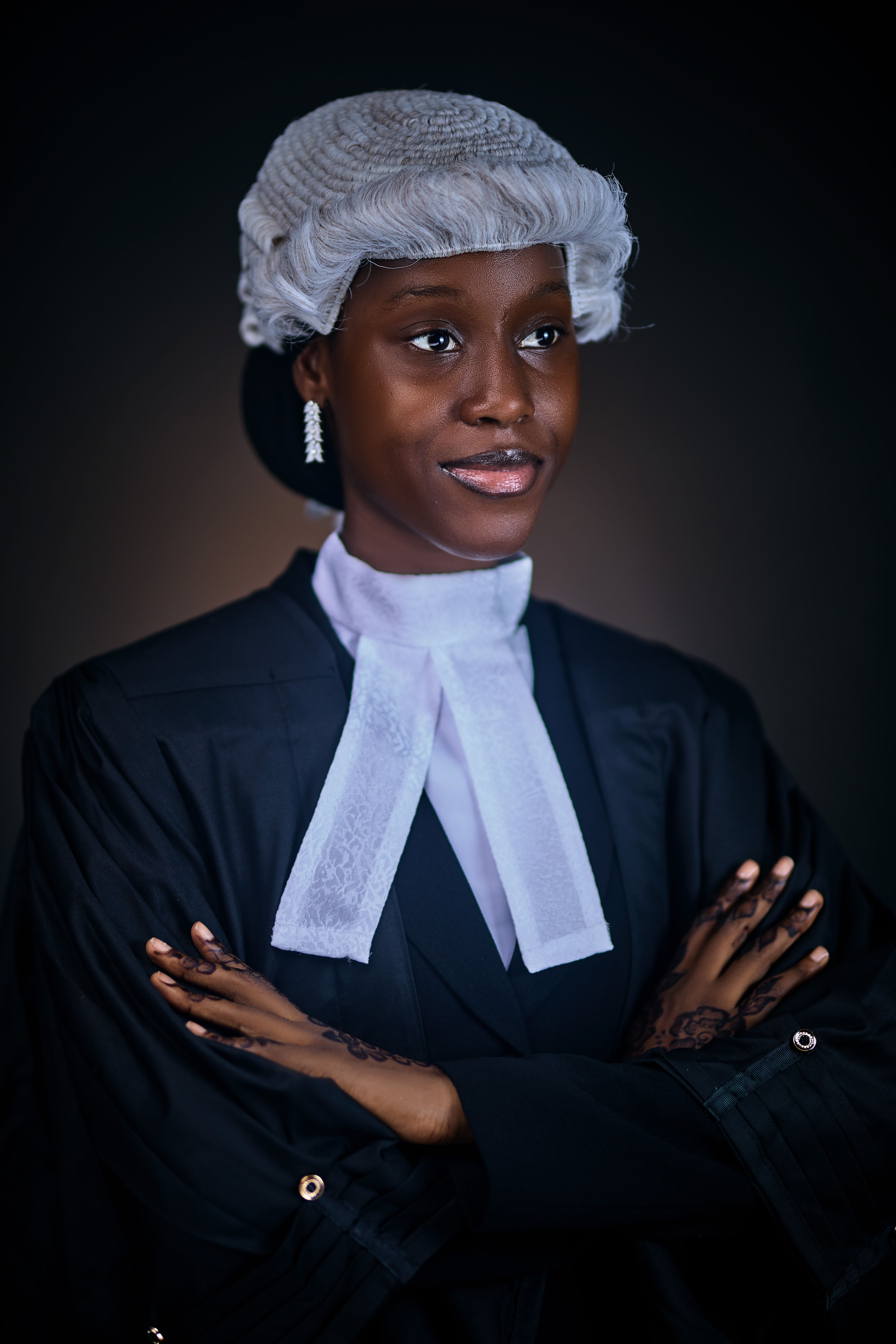 Young female lawyer in traditional attire poses confidently, symbolizing justice and professionalism.