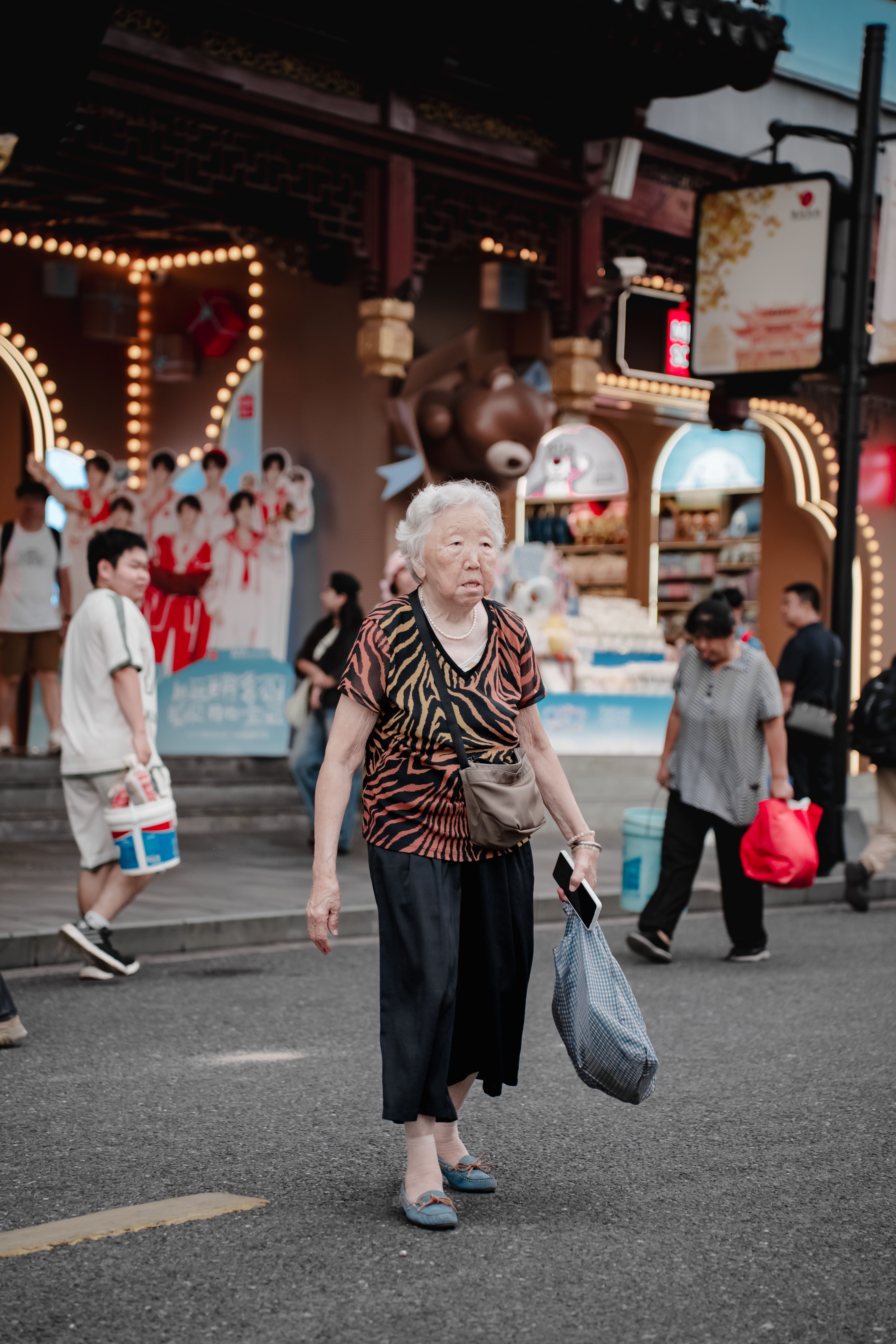 Elderly Woman Crossing a Bustling City Street · Free Stock Photo
