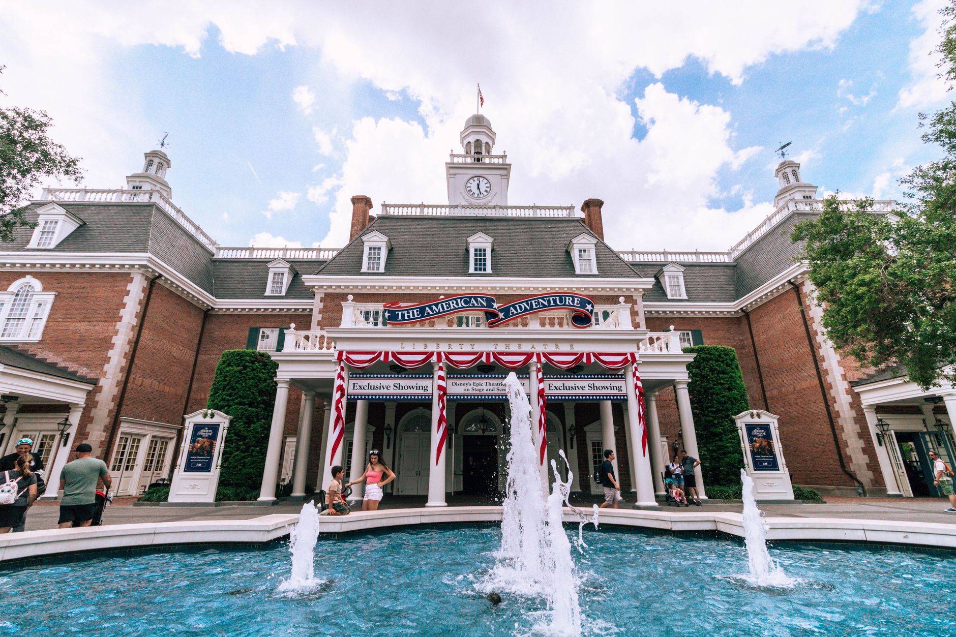 The American Adventure Pavilion at Epcot, featuring a vibrant fountain and colonial architecture.