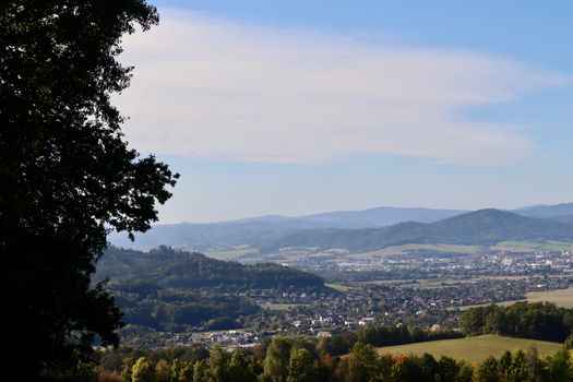 Breathtaking view of a picturesque countryside with rolling hills and a vibrant townscape.