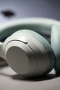 A sleek pair of white and light blue wireless headphones with soft cushioning.