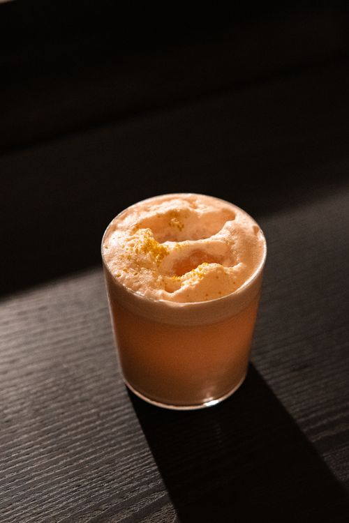 Free A beautifully lit frothy cocktail in a dim bar environment in Tokyo. Stock Photo