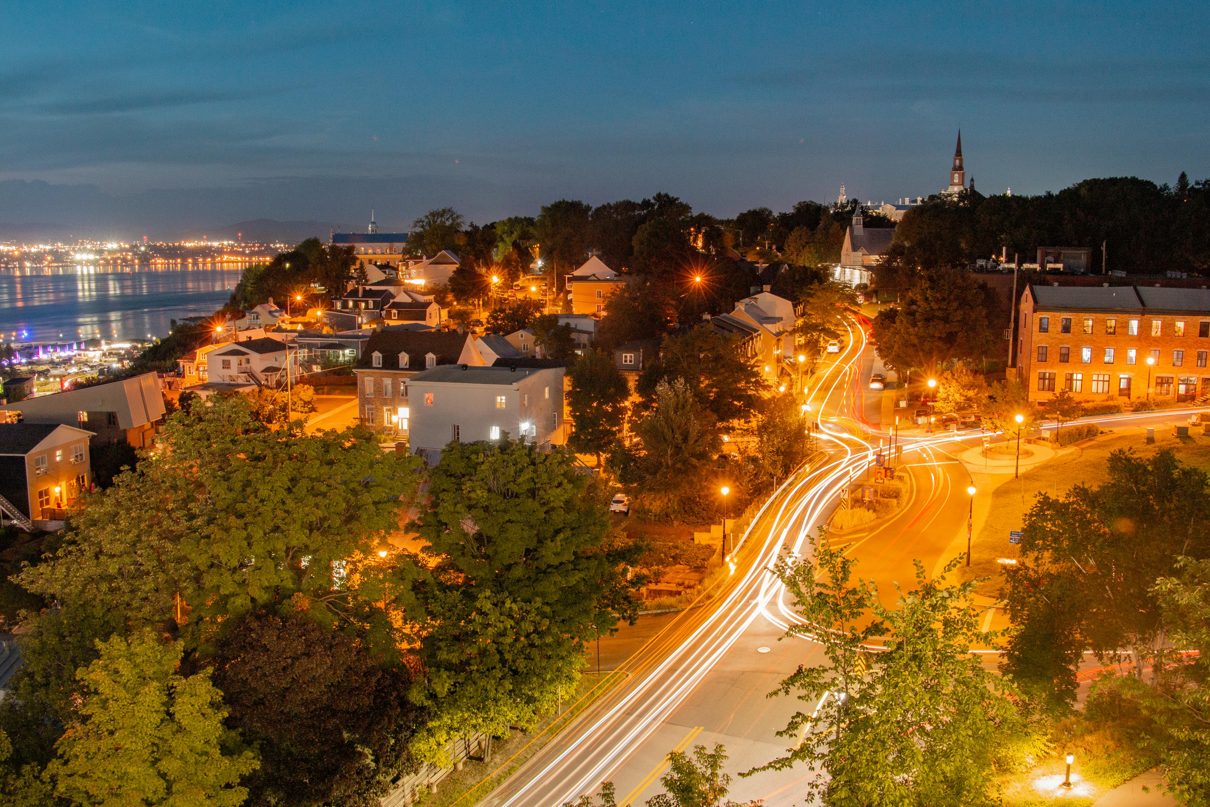 Vibrant night scene in Lévis, Quebec, showcasing illuminated streets and city lights.