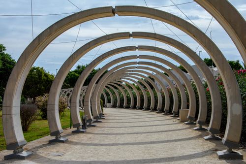 Free Intricate arches form a tunnel in a park at San Vicente del Raspeig, Spain. Stock Photo