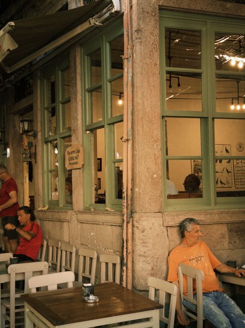 Free Outdoor seating at a vintage cafe with people enjoying their time. Stock Photo