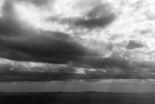 Free Black and white dramatic sky with sun rays over Minas Gerais hills. Stock Photo