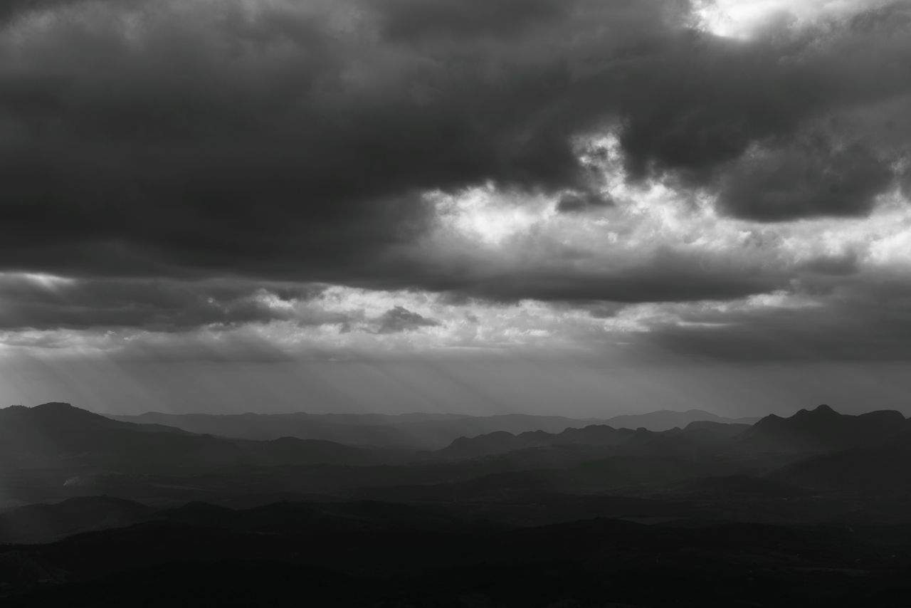 moody black and white photo of cloudy mountains in minas gerais brazil