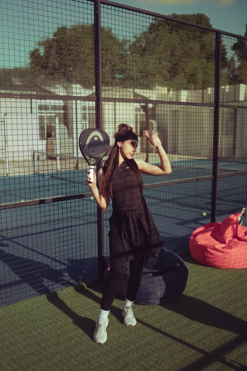 A woman playing padel on an outdoor court