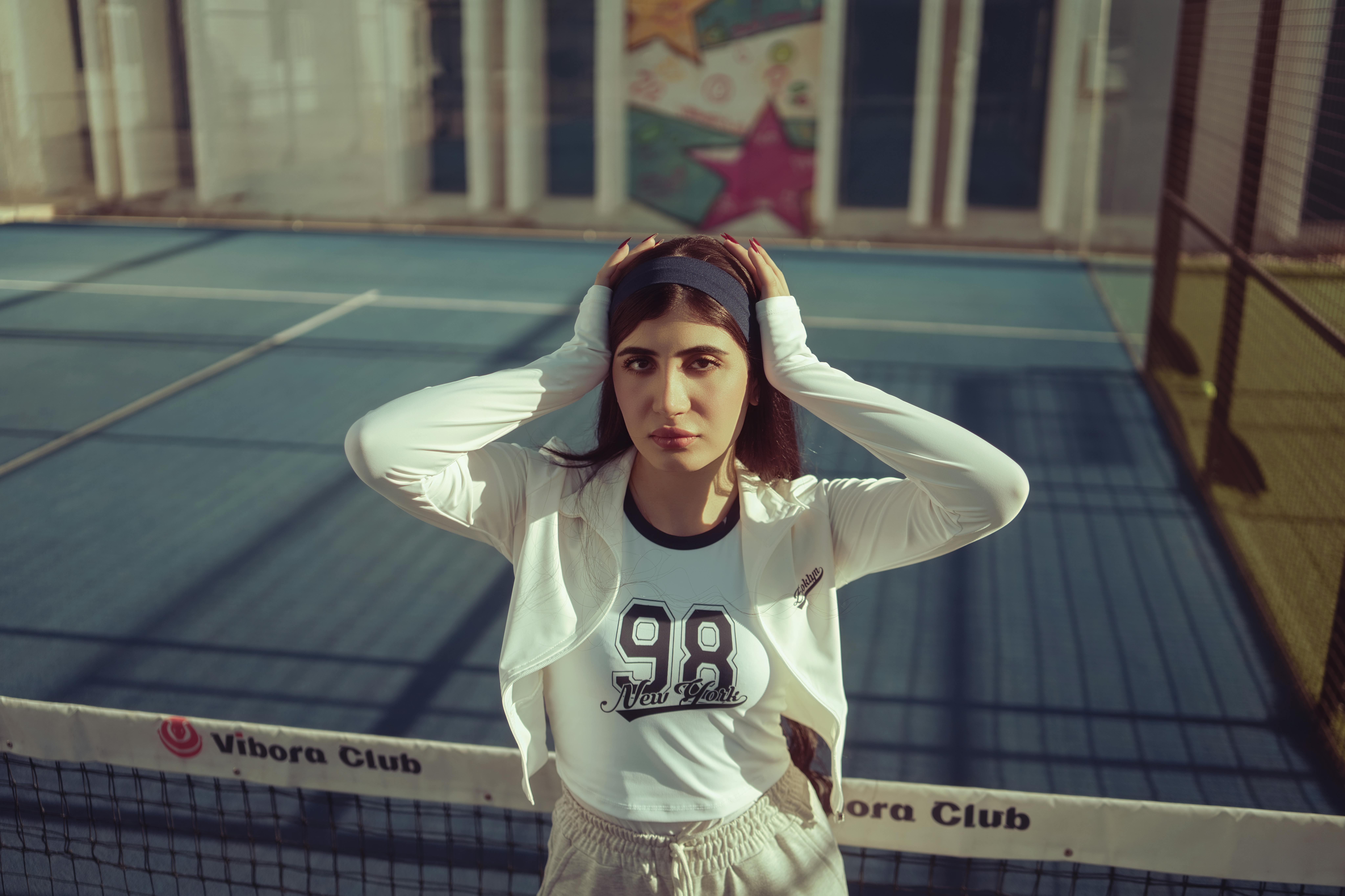 Portrait of a young woman on an outdoor tennis court in Baghdad, Iraq.