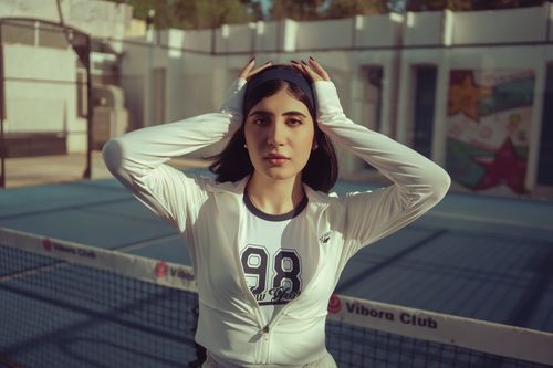 Free A young woman poses confidently on a tennis court in Baghdad, Iraq. Stock Photo