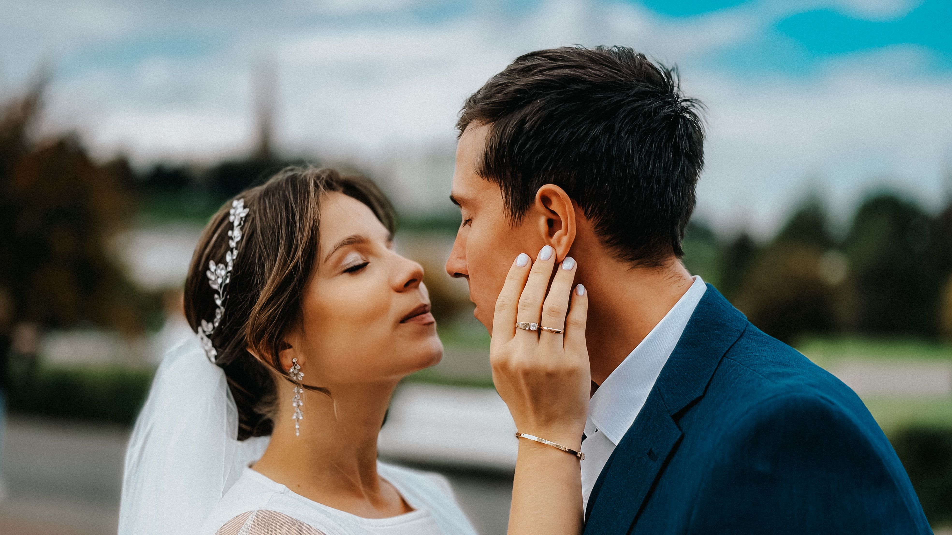 A romantic moment captured between a bride and groom during their outdoor wedding ceremony.