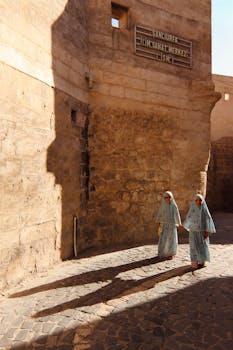 Two children in traditional clothing walk along historic streets in Şanlıurfa, Türkiye.