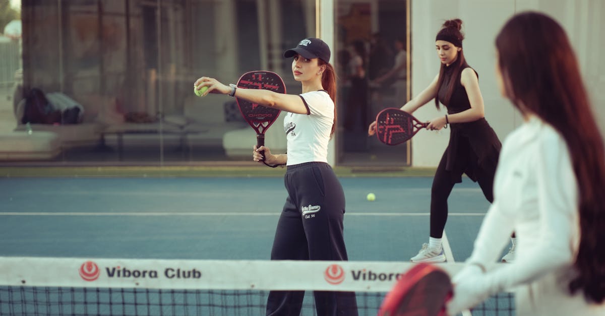 Dynamic scene of women playing padel tennis at Vibora Club in Baghdad, Iraq.