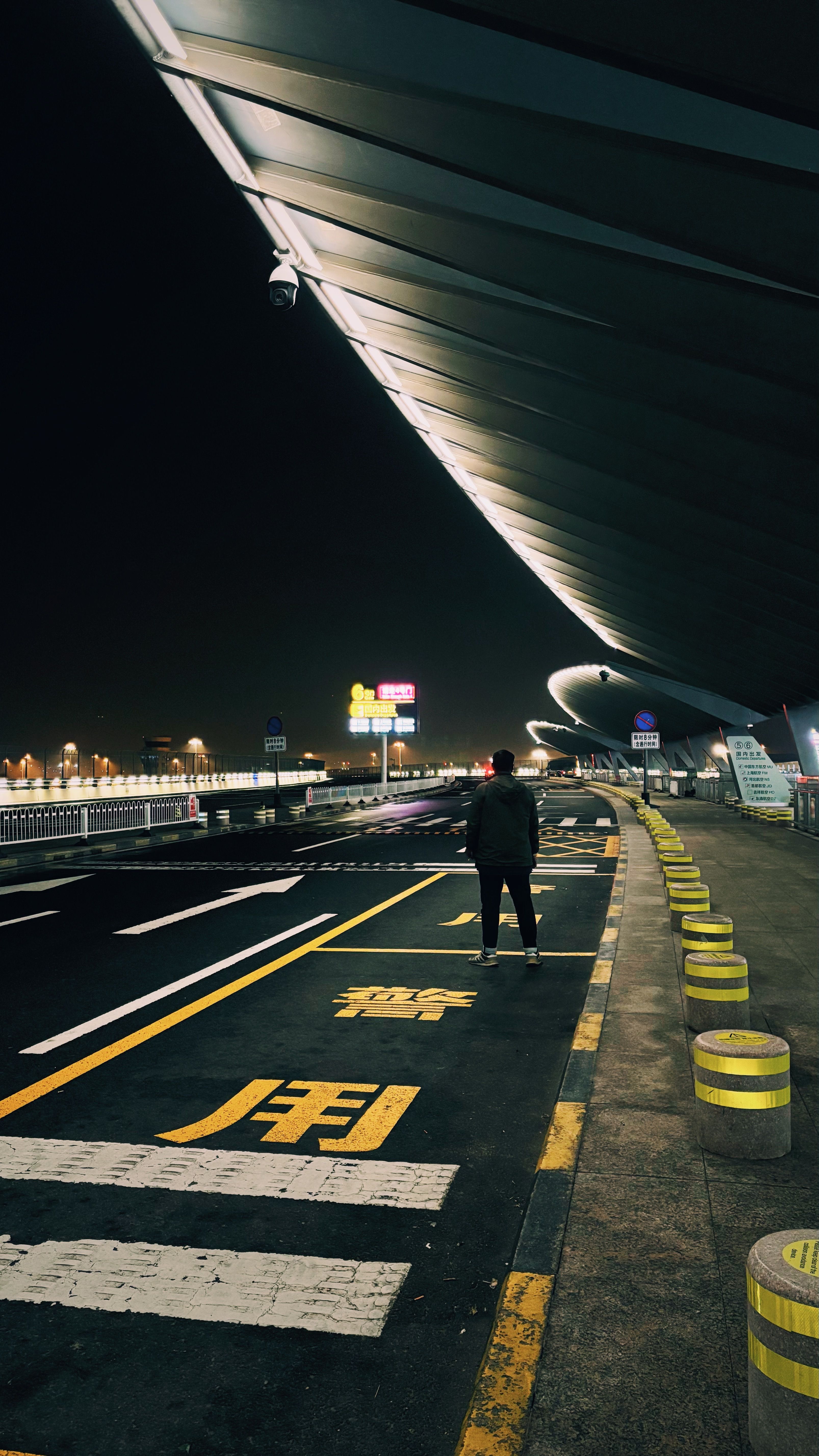 Airport road and terminal lit at night