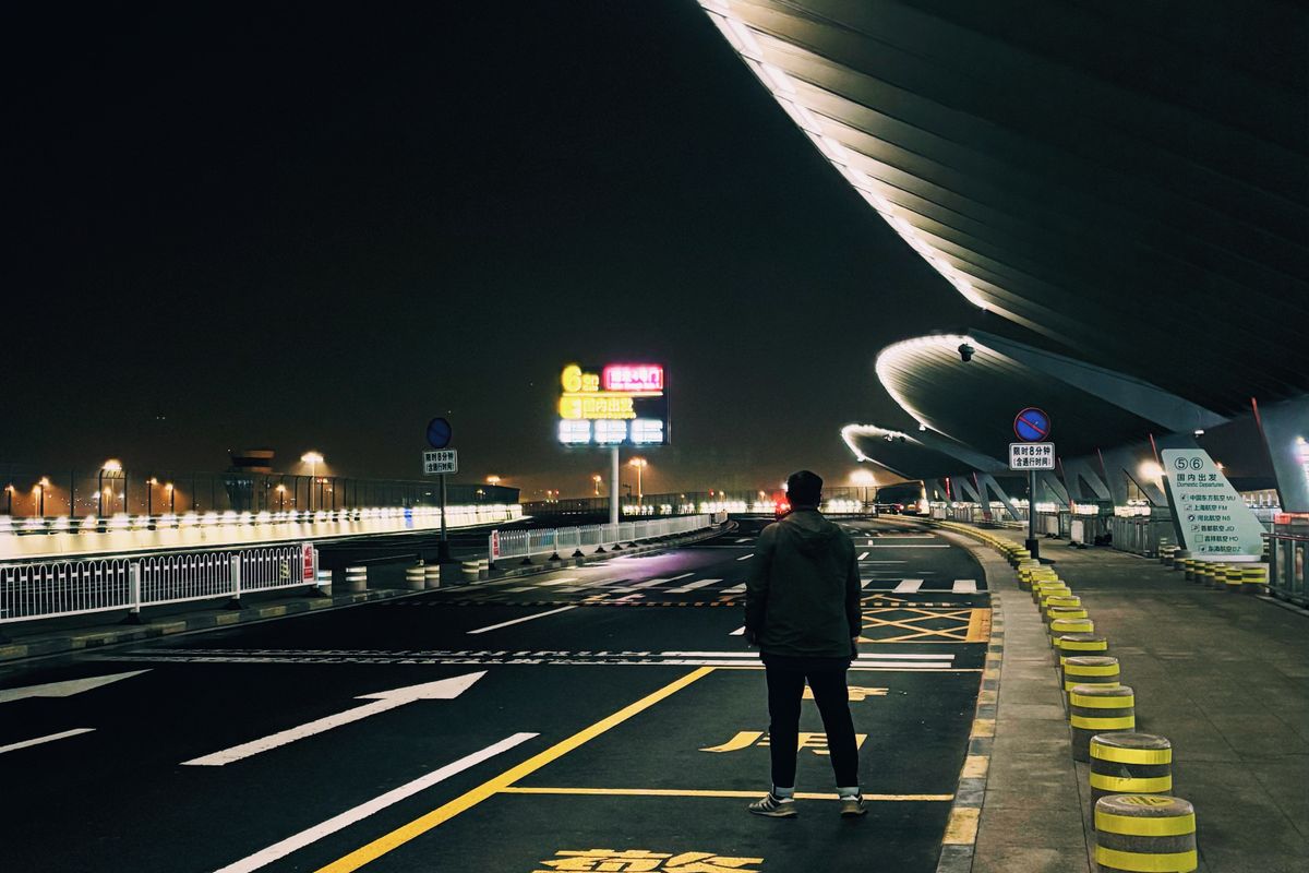 Airport road and terminal lit at night