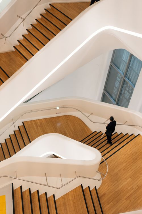 Free A person on a contemporary staircase in a sleek modern building. Stock Photo