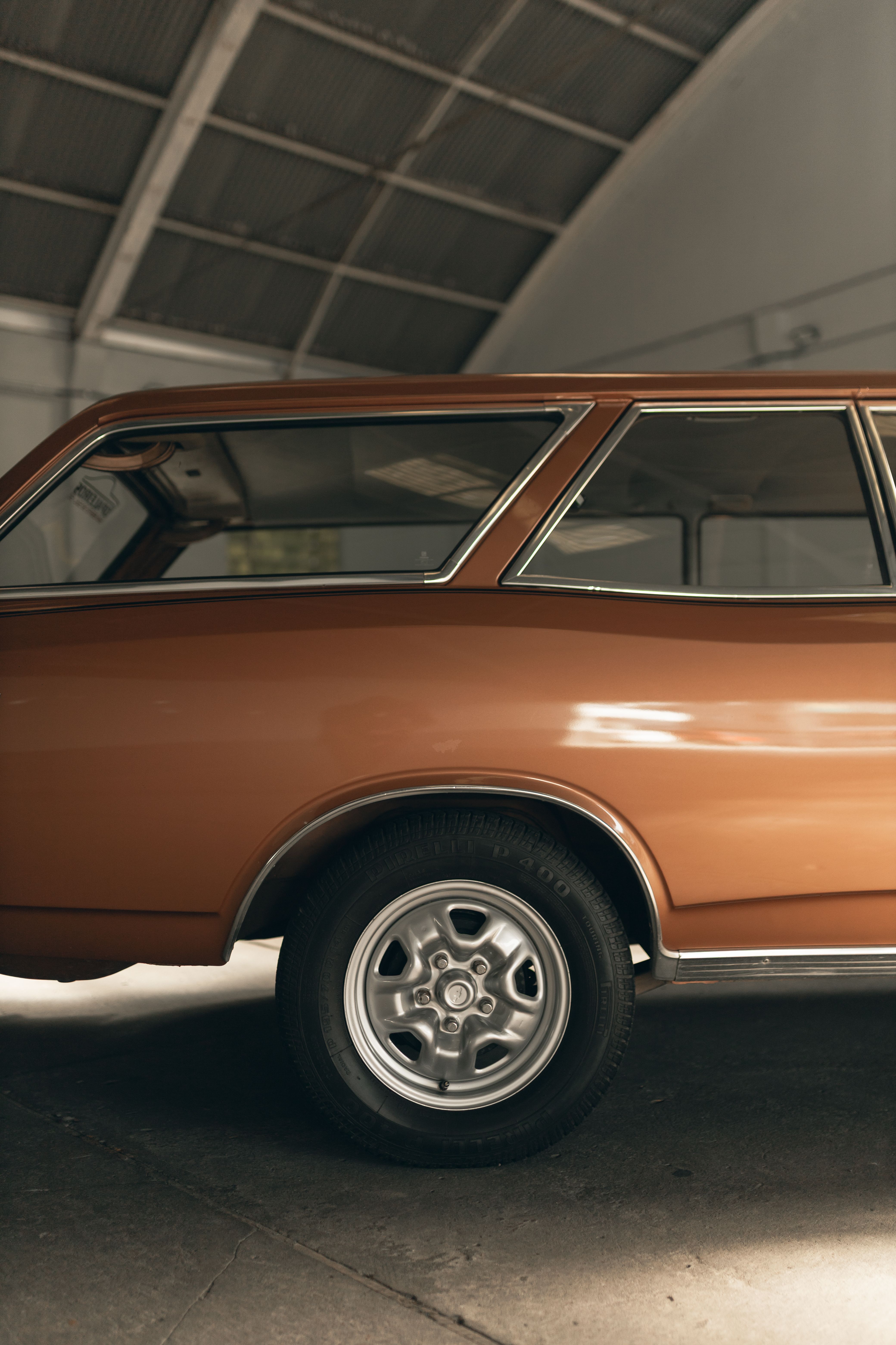 Classic vintage car parked inside a stylish urban garage, showcasing retro automotive design.