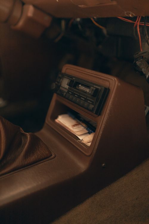 Free Vintage car dashboard featuring a classic cassette player and storage space. Stock Photo