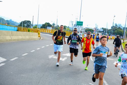 Free Marathon runners on a city road, showcasing energy and determination. Stock Photo