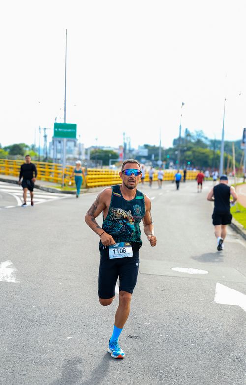 Free Focused athlete running in a city marathon with determination and energy. Stock Photo