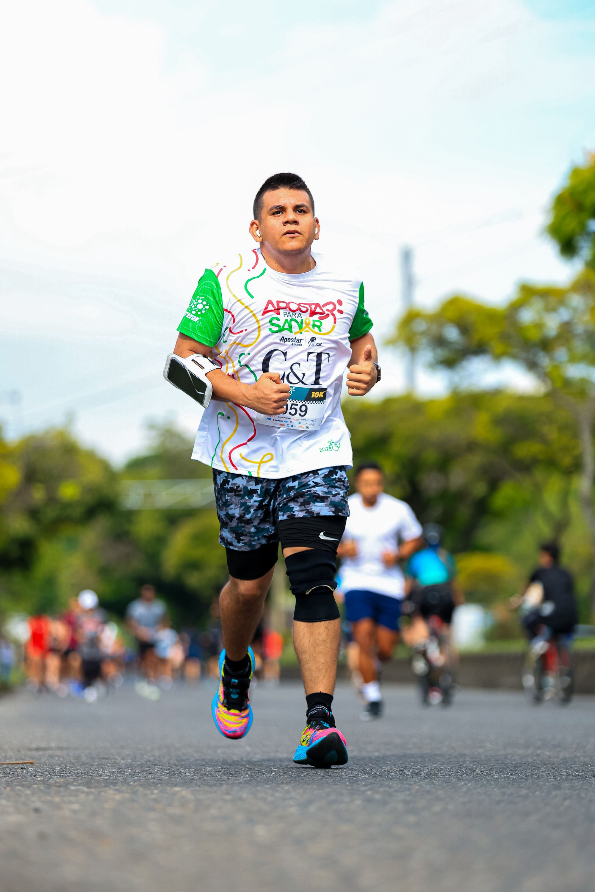 Focused young athlete running in a vibrant outdoor marathon event.