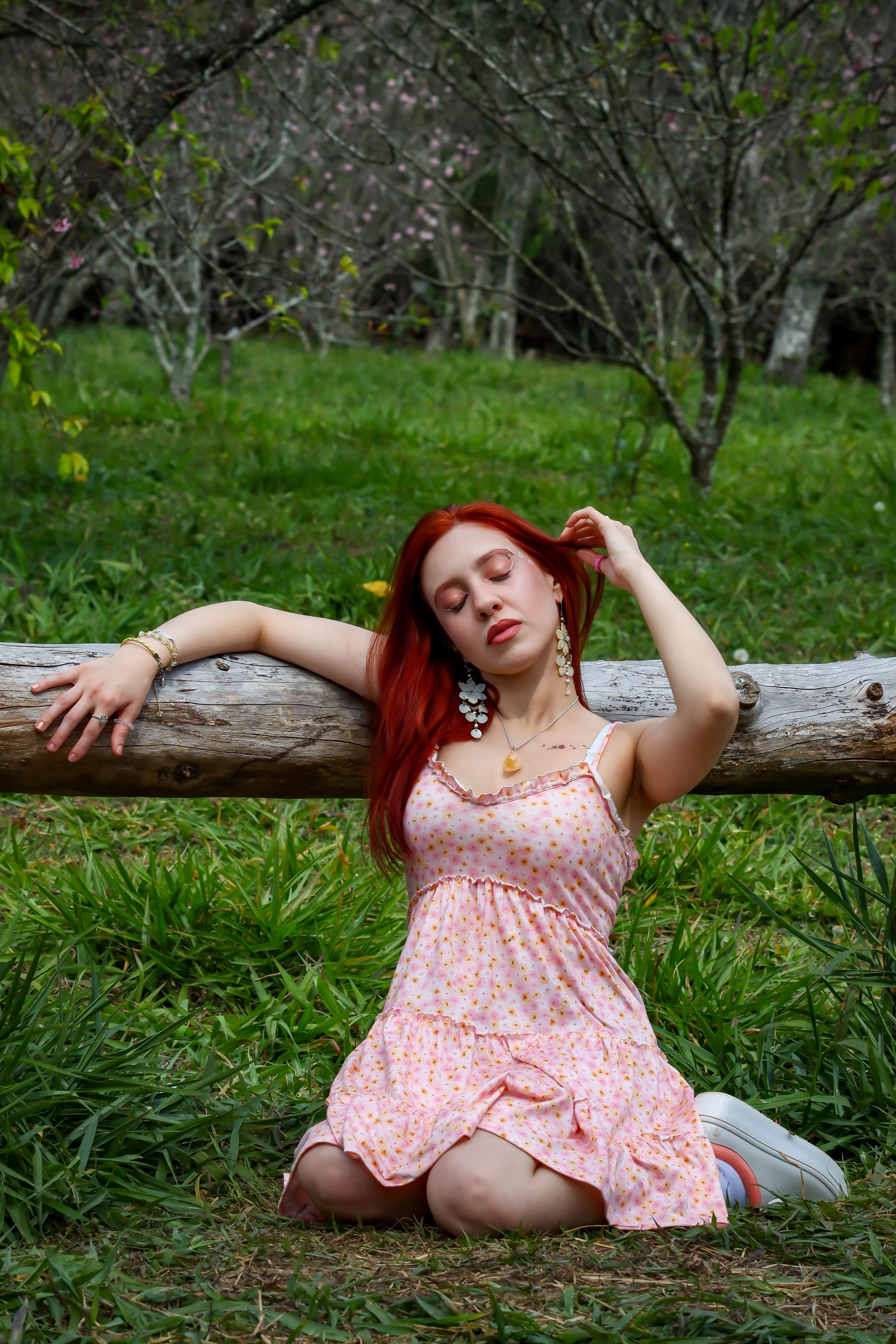 Serene Woman in Floral Dress Relaxing Outdoors · Free Stock Photo
