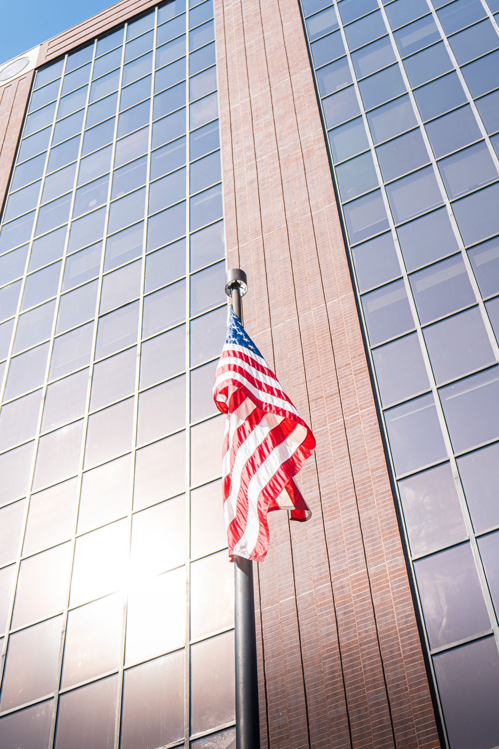 American Flag With Modern Glass Building Backdrop Free Stock Photo american-flag-with-modern-glass-building-backdrop-free-stock-photo