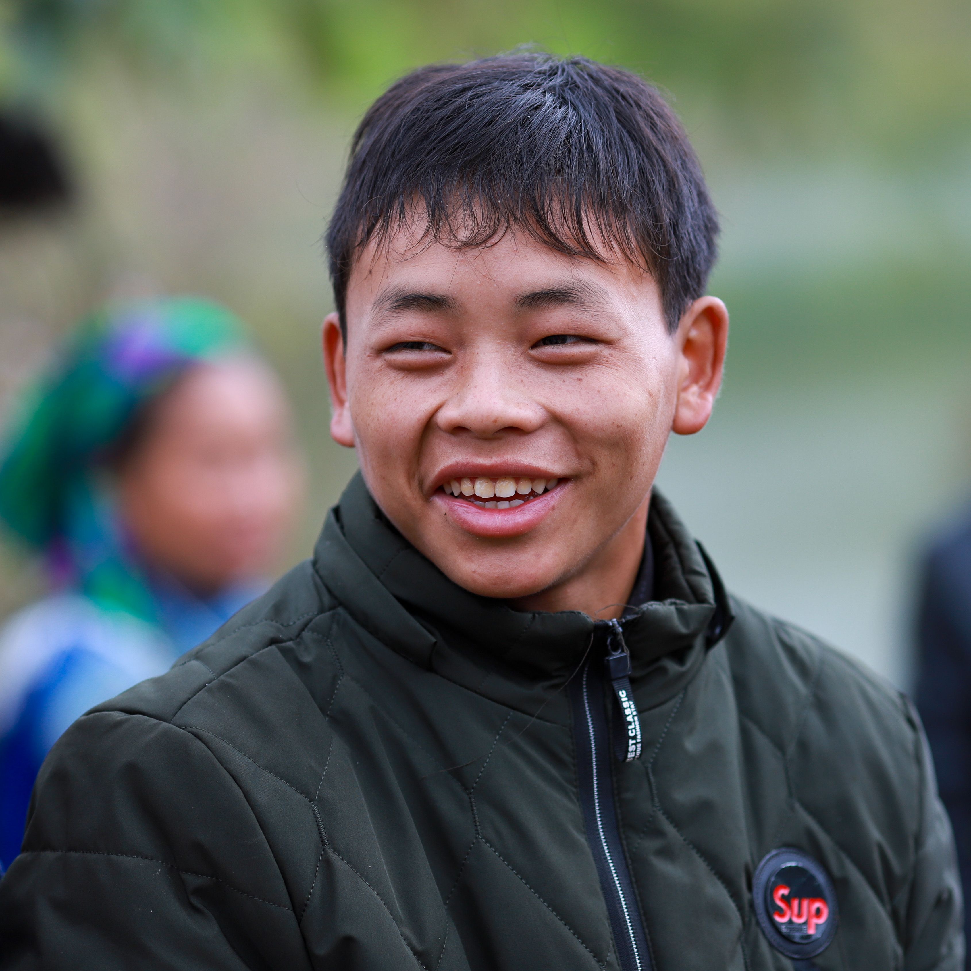 Smiling Young Man in Traditional Hmong Clothing · Free Stock Photo