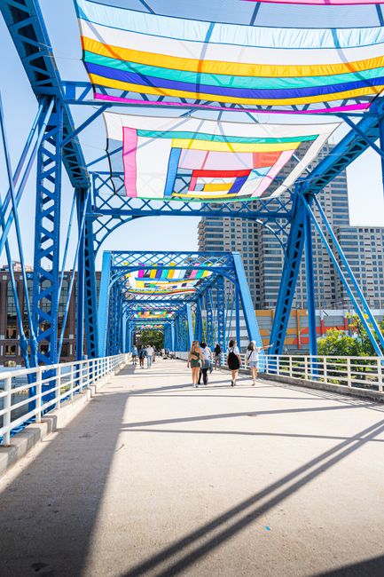 A vibrant public art installation adorns the iconic Blue Bridge in Grand Rapids, Michigan.