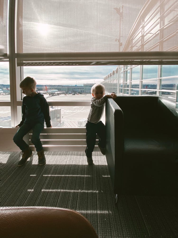 Children Playing Near Glass Panel