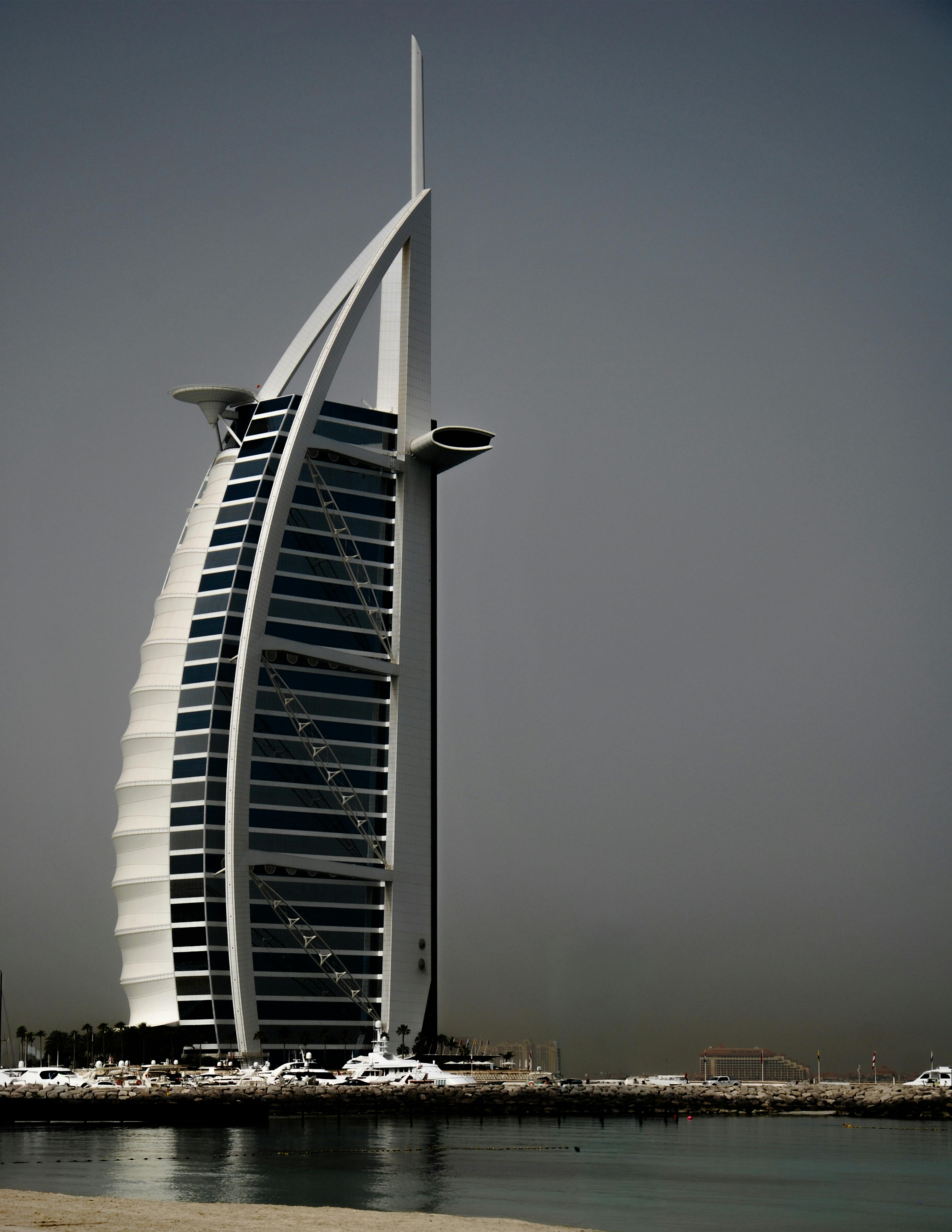 Iconic Burj Al Arab in Dubai captured against a clear sky, showcasing modern luxury architecture.