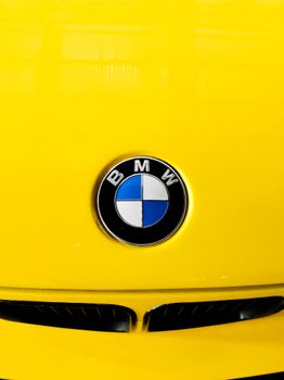 Bright yellow BMW car hood with iconic emblem, shot in Kochi, India. 34084127