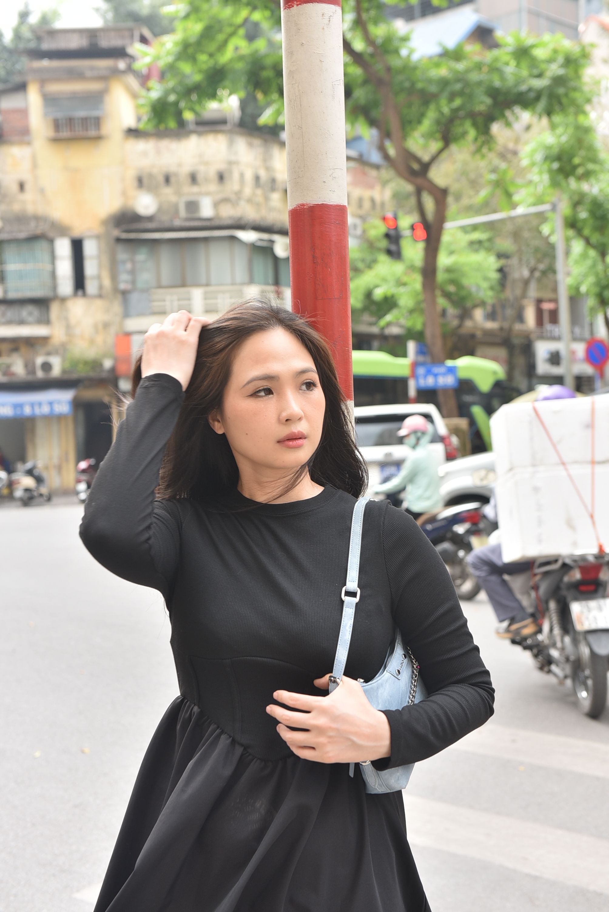 Young Woman on Urban Street in Black Dress · Free Stock Photo