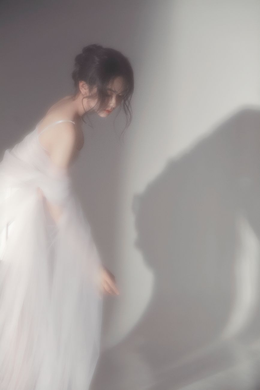 Artistic portrait of a woman in soft focus, creating a dreamy and ethereal effect.
