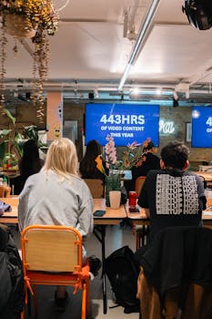 Interactive team meeting in a modern office discussing 443 hours of video content, fostering collaboration.