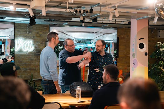 Three adults engaging in a collaborative discussion in a modern office setting.