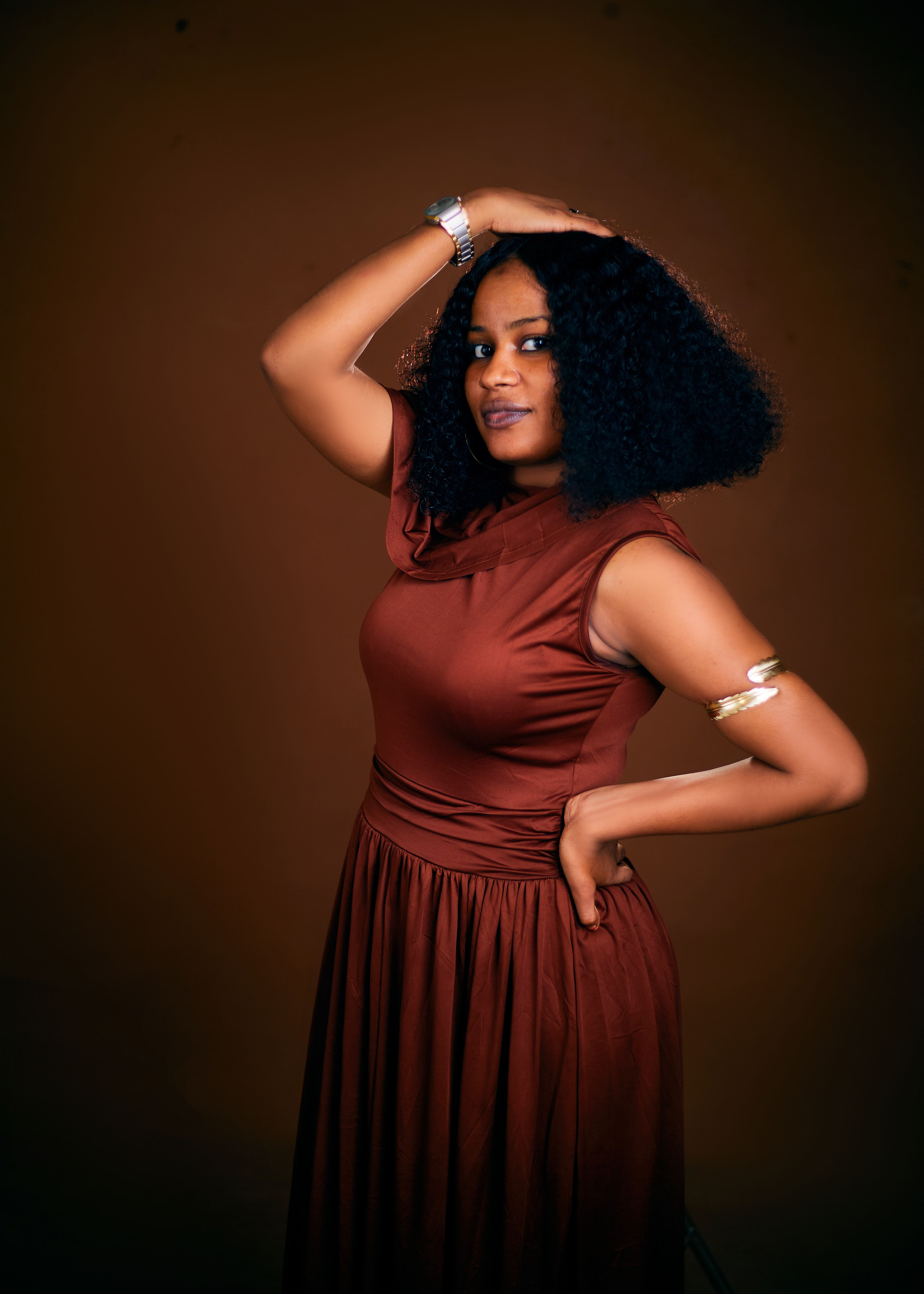 Elegant Woman in Rich Brown Dress Posing · Free Stock Photo — free download