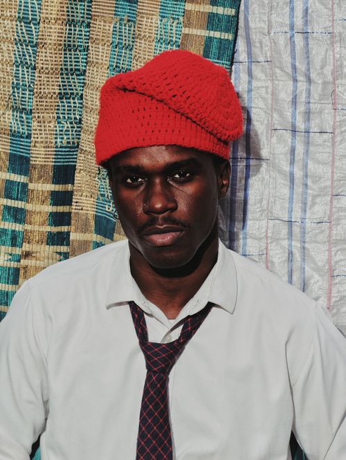 Free Stylish portrait of a man wearing a red knitted hat and white shirt with tie. Stock Photo