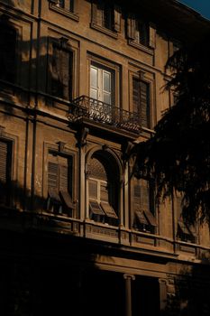 A historic building in Istanbul cast in warm sunset light, highlighting architectural details and shadows.