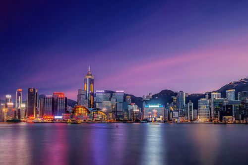Free Stunning view of Hong Kong's skyline with colorful lights reflected on the water during twilight. Stock Photo