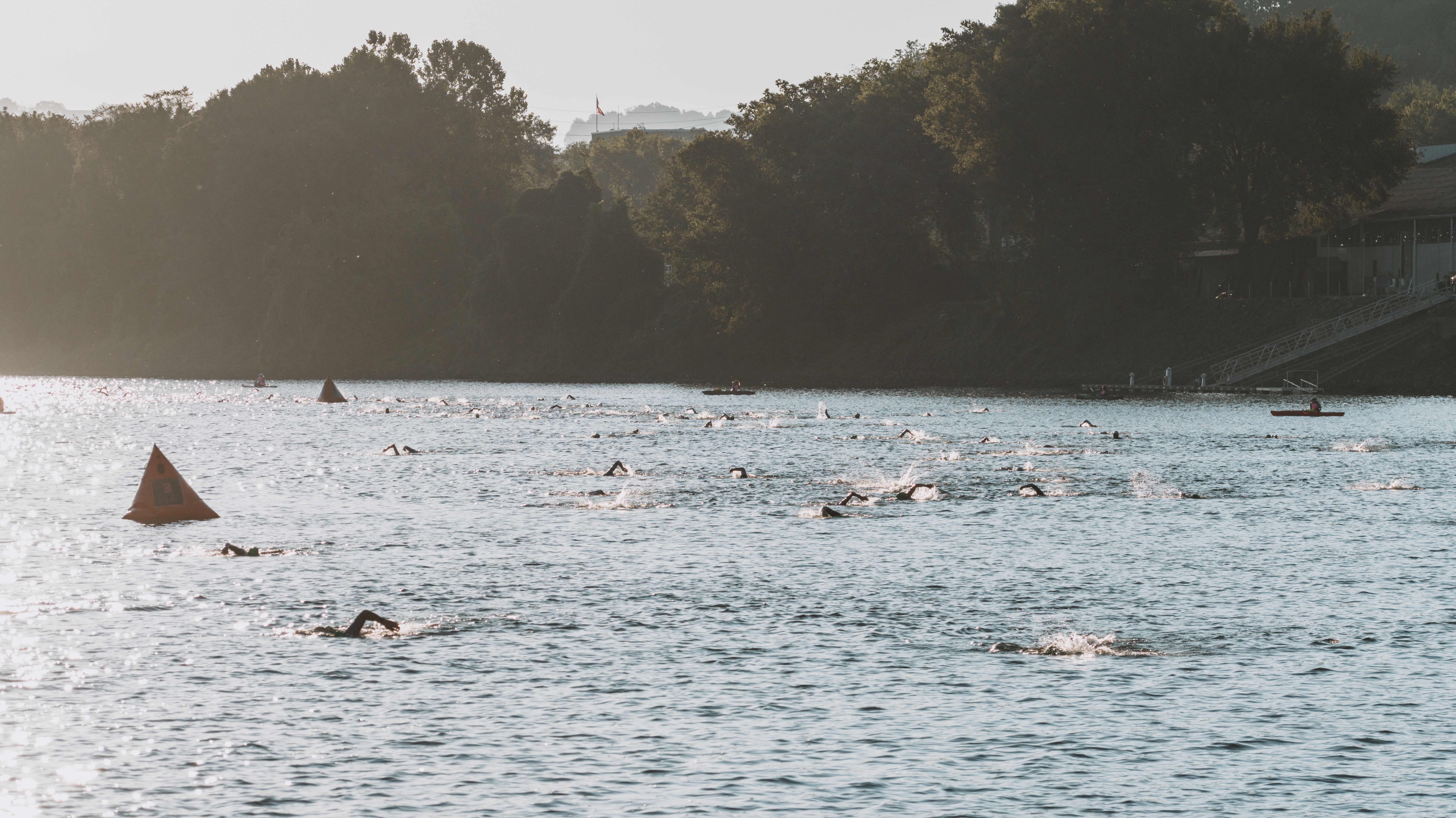 Swimmers participating in a river race event in Chattanooga, Tennessee, captured from an aerial view.