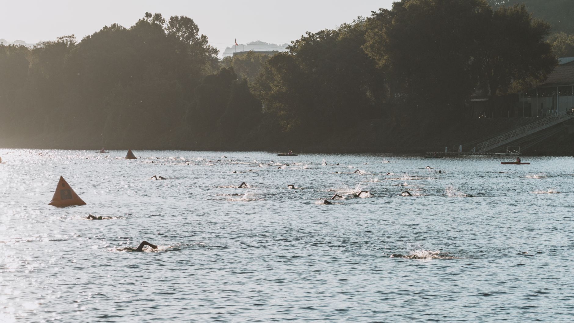 Swimmers participating in a river race event in Chattanooga, Tennessee, captured from an aerial view.