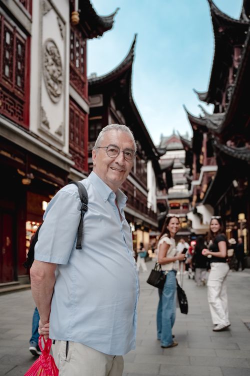 Free Tourists enjoying a walk in a traditional Chinese street, capturing cultural architecture. Stock Photo