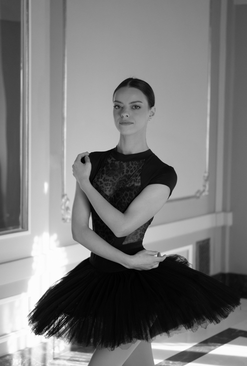 Free Black and white photo of a graceful ballerina posing elegantly indoors. Stock Photo