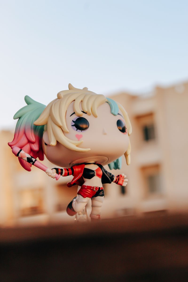 Colorful figure toy against urban backdrop showing urban art toys and graffiti collectibles culture in designer toy scene